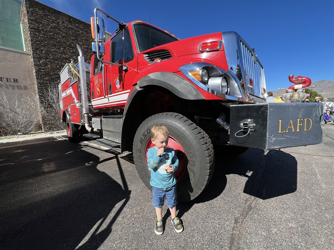 Wildfire Day boy standing by LAFD truck